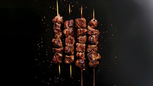 Meat on four skewers, ready to serve for an outdoor grill party