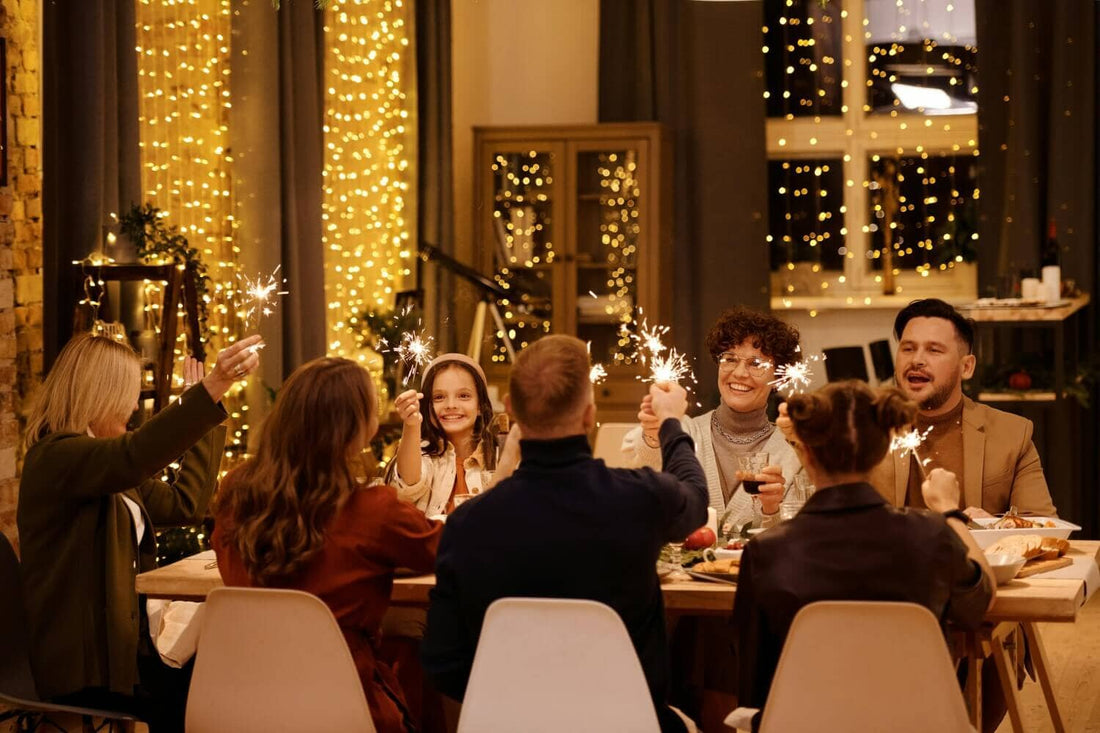 Group of people use sparklers at a dinner party