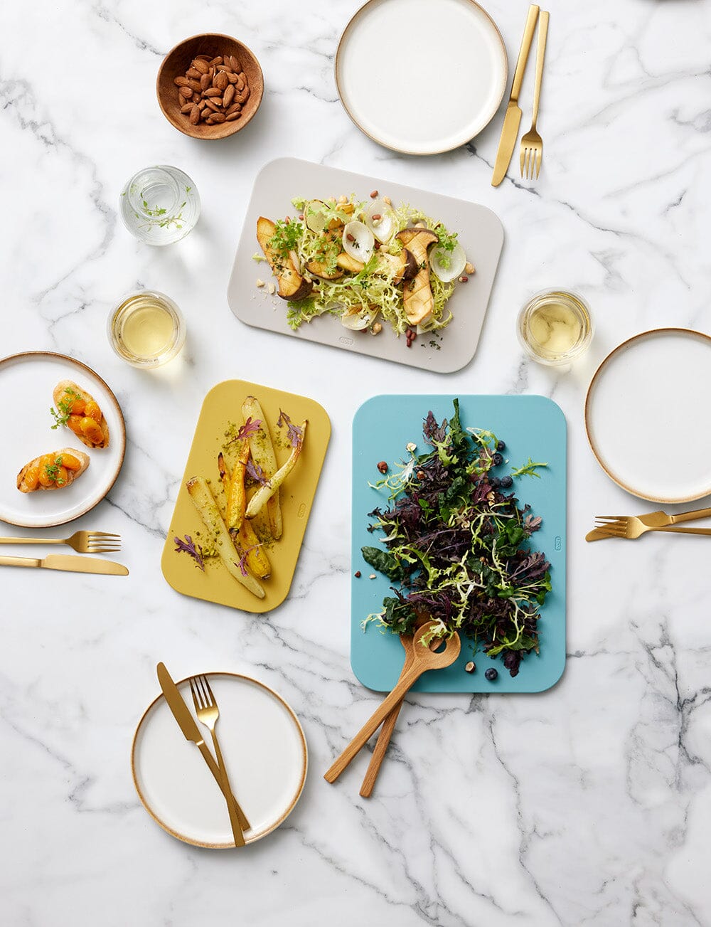 set of chopping boards and plates on counter with food