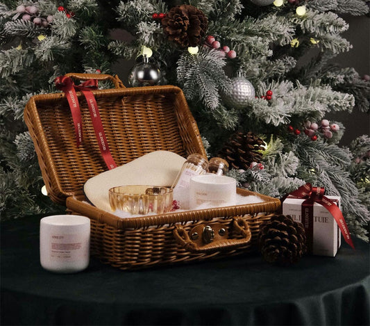 A basket of gifts underneath a Christmas tree