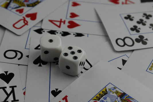 Dice and playing cards scattered in a close-up shot