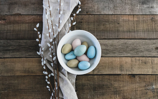 A bowl of Easter eggs on a wooden table for Easter dinner celebrations.