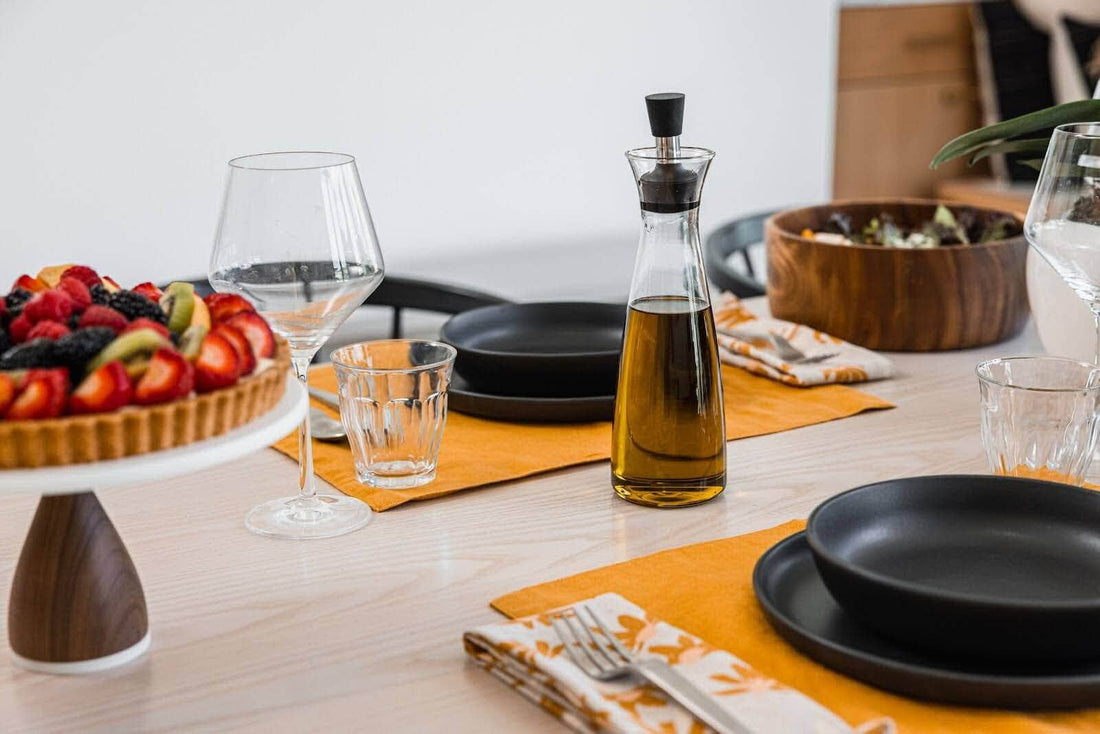 Table set for brunch party with yellow placemats and fruit tart