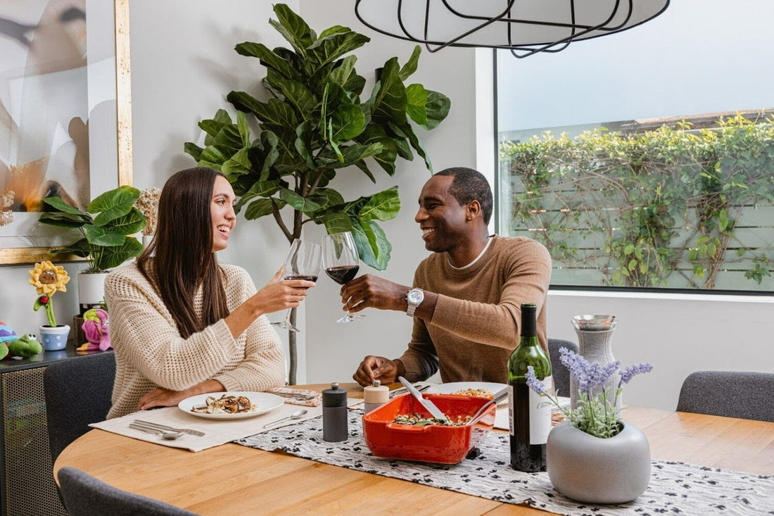 two people cheers wine glasses over a dinner date