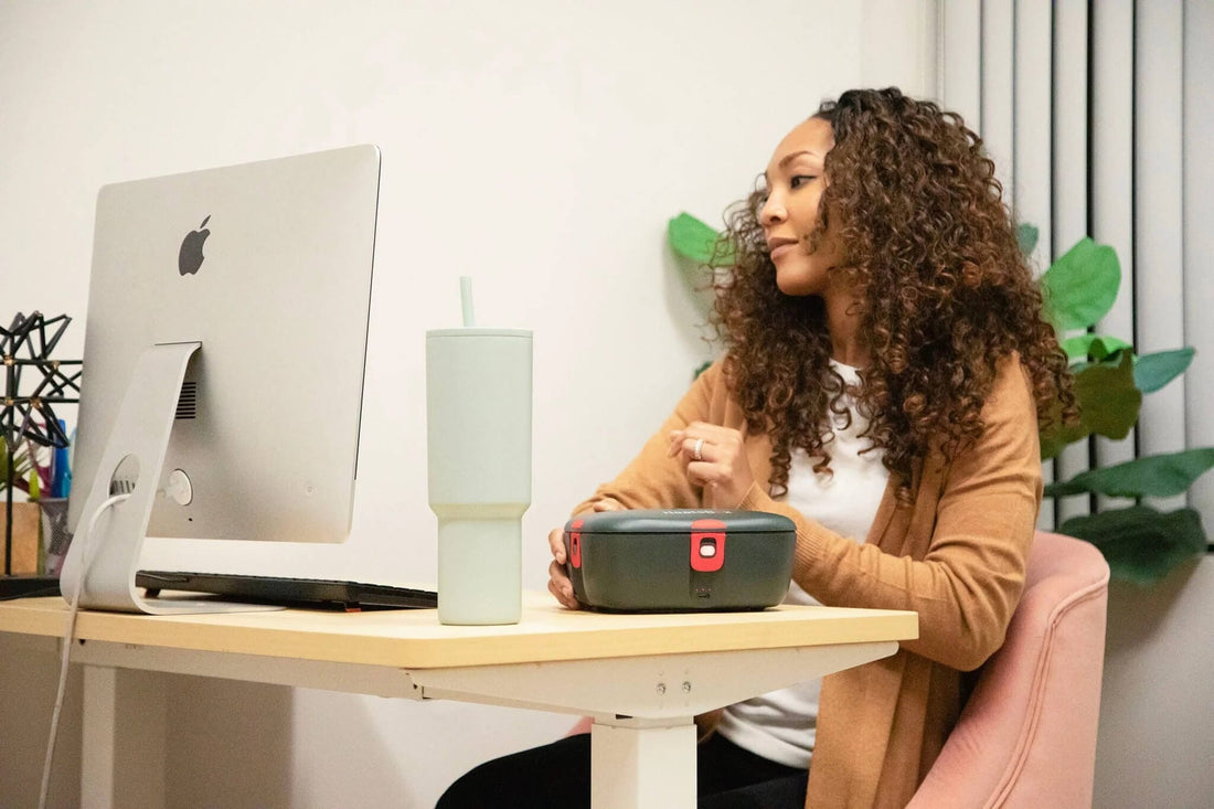 woman with heated lunchbox on table