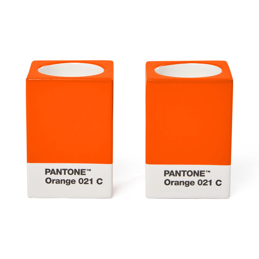 Two Copenhagen Design Pantone Orange 021 candle holders without candles, showing the recessed candle openings