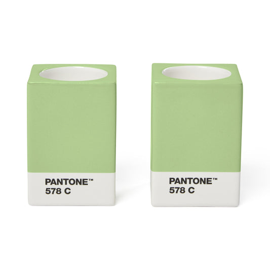 Two Copenhagen Design Pantone Light Green 578 candle holders without candles, showing the recessed candle openings