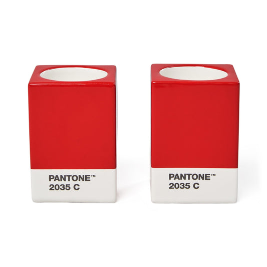 Two Copenhagen Design Pantone Red 2035 candle holders without candles, showing the recessed candle openings