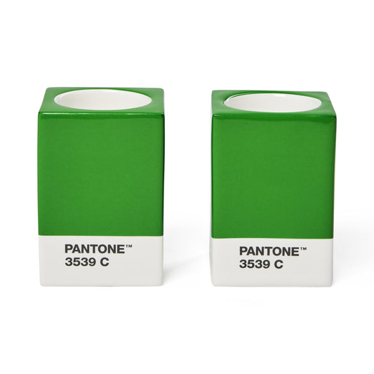 Two Copenhagen Design Pantone Green 3539 candle holders without candles, showing the recessed candle openings