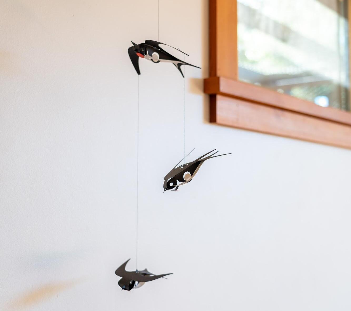 Swallow suncatcher hanging by window