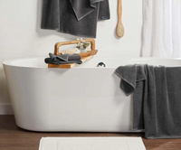 Bath tub set up with bath caddy and towels